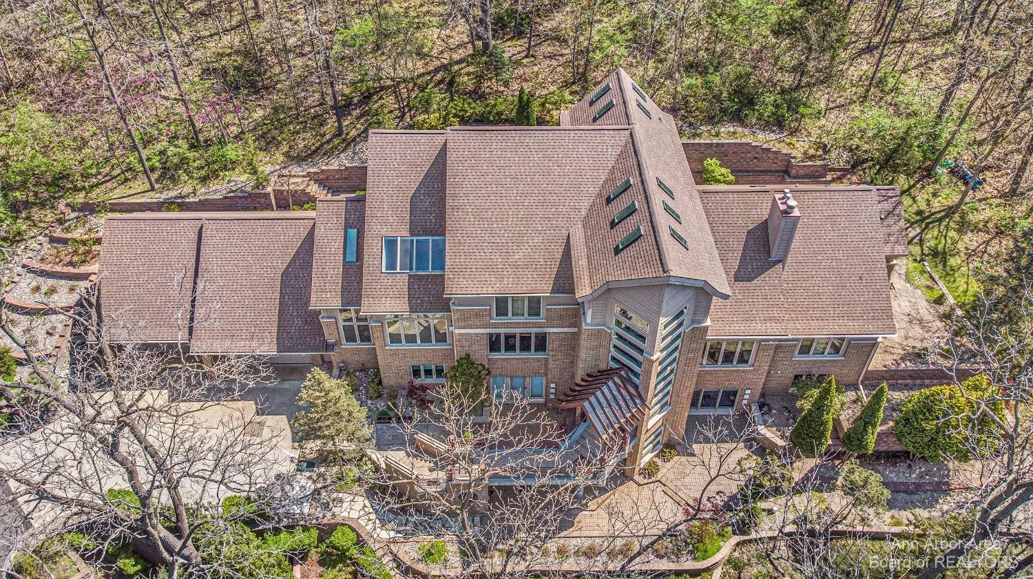330 Meadow Creek Dr framed by trees in Ann Arbor